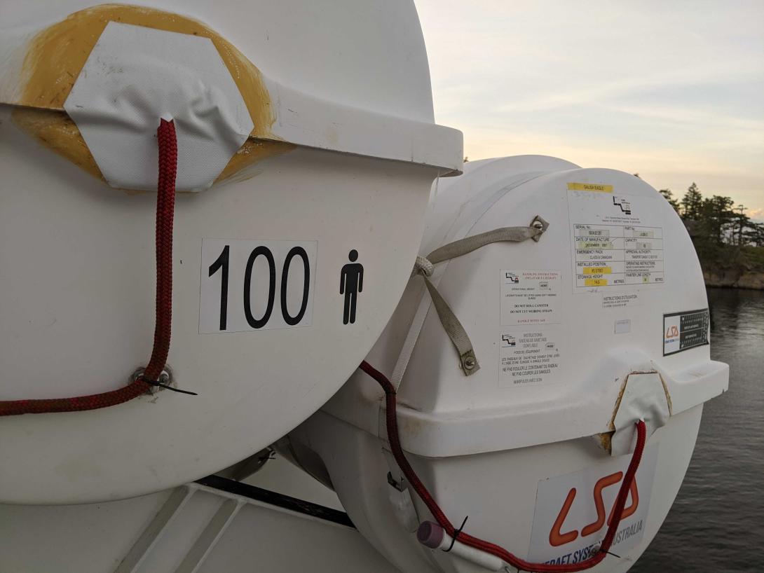 a lifeboat container with the number 100 and a little stick figure. that's a lot of life.